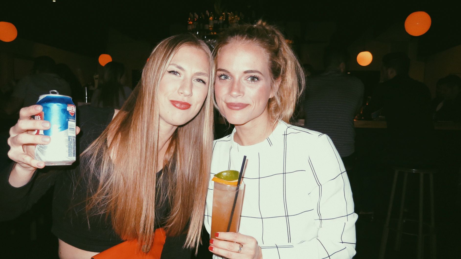 two girls drinking at a bar