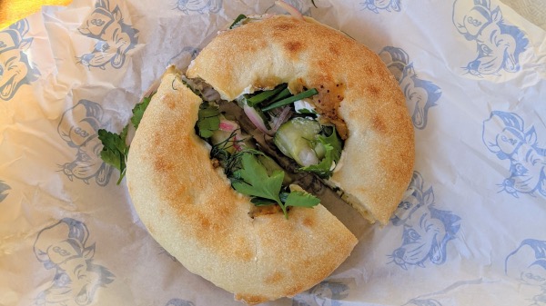 deli desire labneh sandwich, a bialy with cucumber onion, mint, and dill