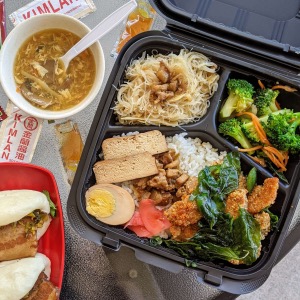 meal box with chicken and egg with vegetables and soup