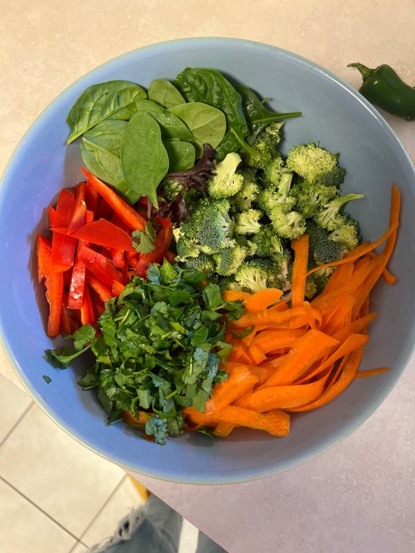 salad of spinach carrots red pepper and cilantro